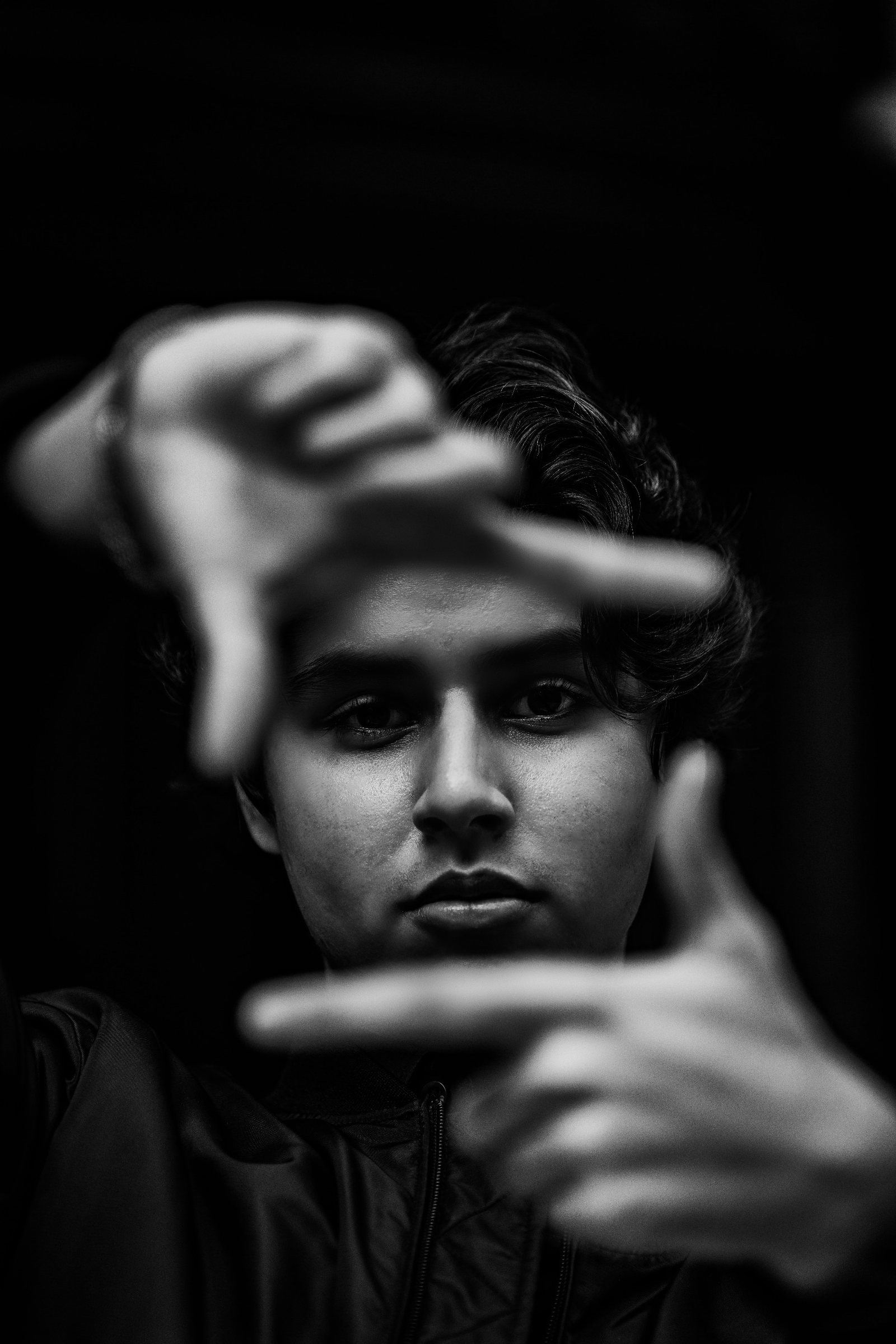 Nekki Sehmbi framing a shot with his hands, black and white